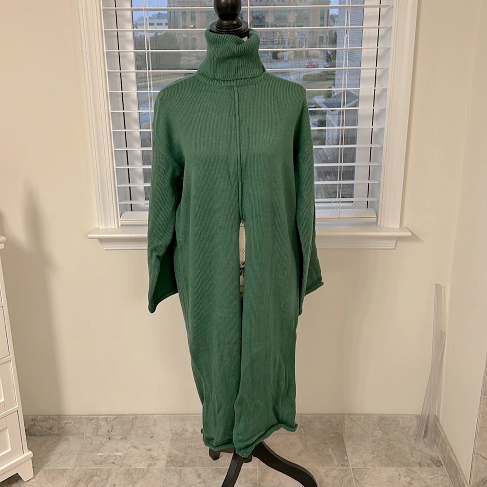 Long sweater with slit in middle.